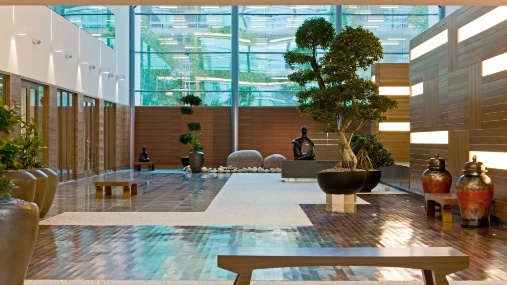 Sofitel London Heathrow grand lobby atrium with bonsai trees and sculptures