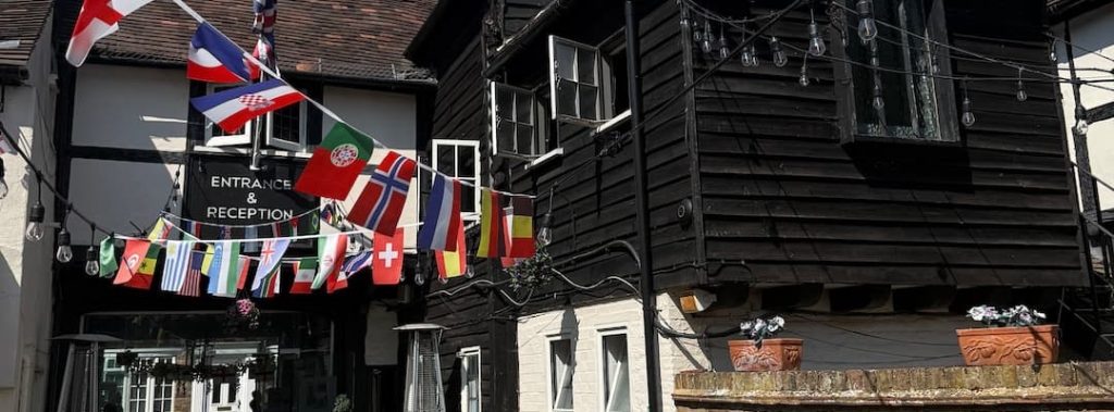 The Ostrich Inn at Colnbrook, its black timbered upper storey and bunting over the entrance