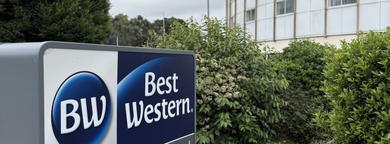 The Best Western sign on Bath Road with the curved front of the Best Western Heathrow behind it