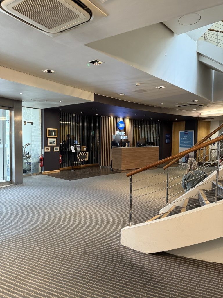 The lobby and reception of the Best Western Heathrow, with the staircase to one side