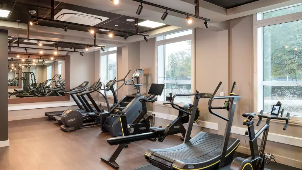 Gym at the Hilton Garden Inn at Hatton Cross, with treadmills and bikes beside full height windows