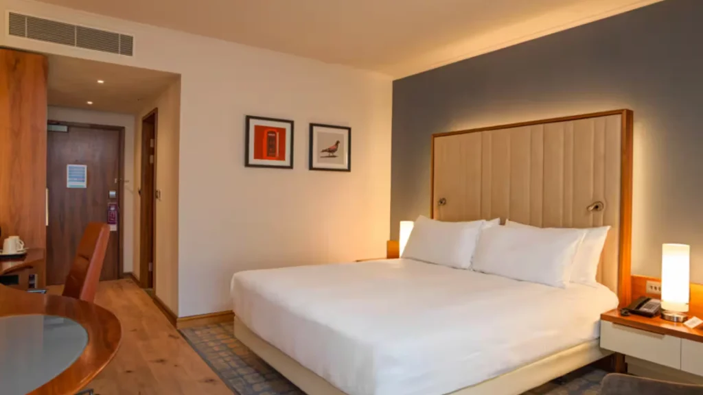 King bedroom at the Hilton London Heathrow Terminal 5, with a padded headboard and a work desk