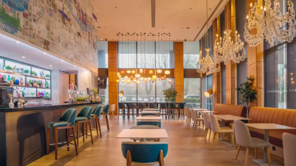 The River Bar at the Hilton London Heathrow Terminal 5, with copper pendant lights and banquette seating