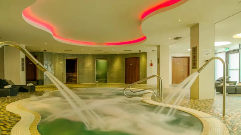 Spa pool at the Hilton London Heathrow Terminal 5, with water jets and a curved red ceiling light