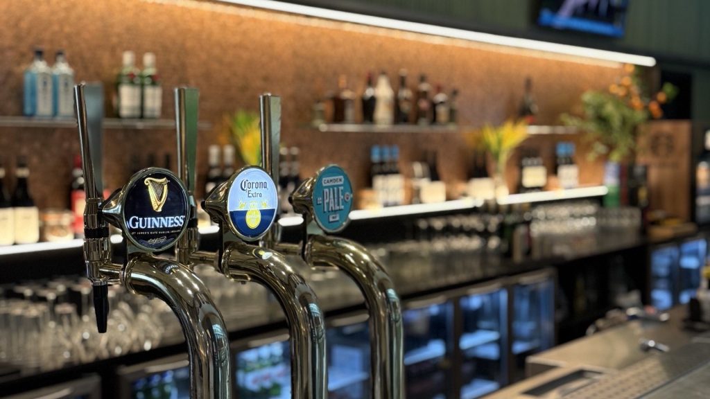 Beer taps along the bar, including Guinness