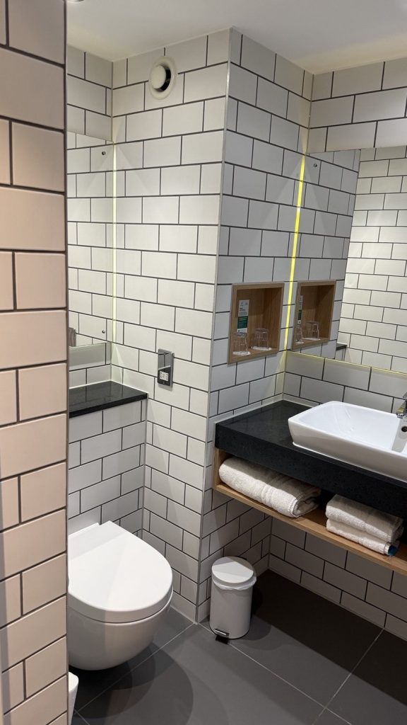 A tiled bathroom with a walk-in shower