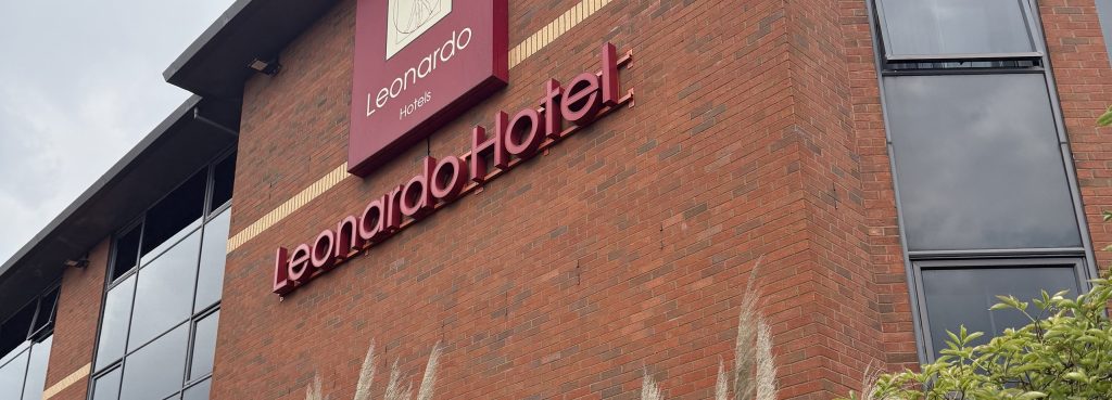 The Leonardo Hotel sign on the brick frontage, with the hotel name in lettering below it