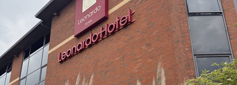 The Leonardo Hotel sign on the brick frontage, with the hotel name in lettering below it