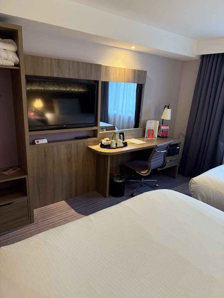 The desk and television in a guest room