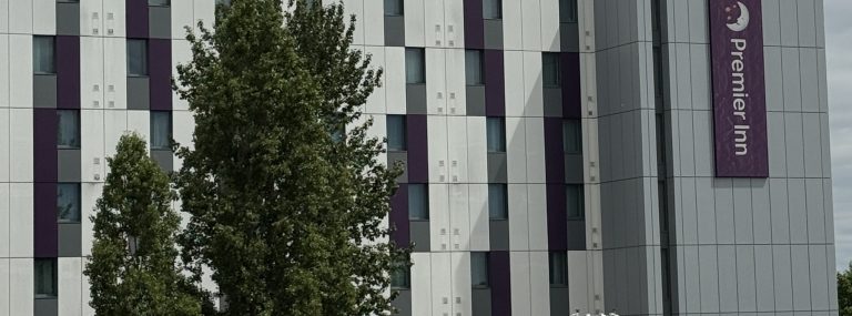 The facade of the Premier Inn Heathrow Terminal 4 with the purple Premier Inn sign
