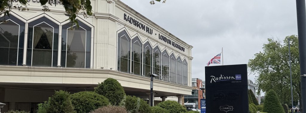 The Radisson Blu Edwardian Heathrow on Bath Road, with the hotel name along the front and the entrance sign beside it