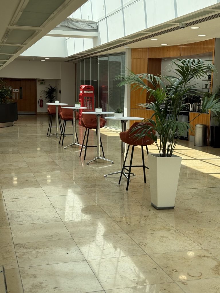 The marble-floored lobby, with seating and a bar counter beyond