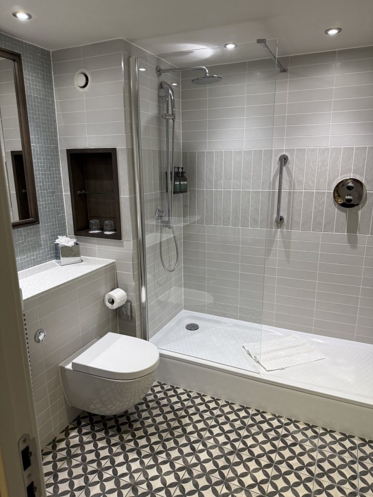 A bathroom with a walk-in shower