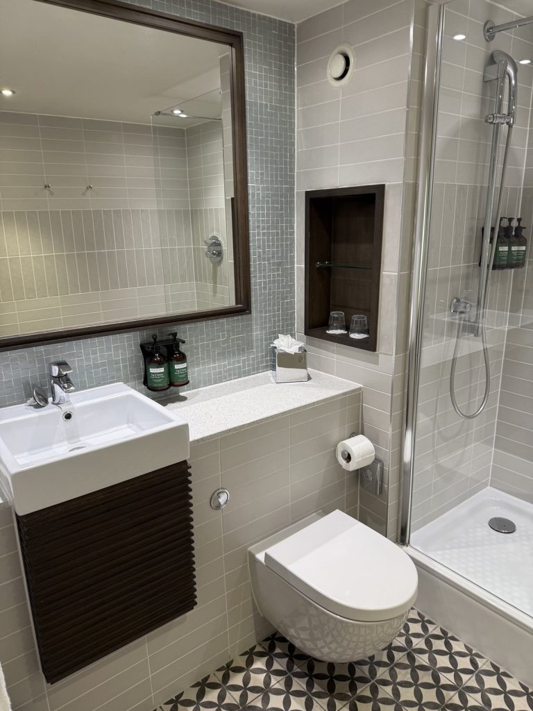 The bathroom basin, with the shower beyond