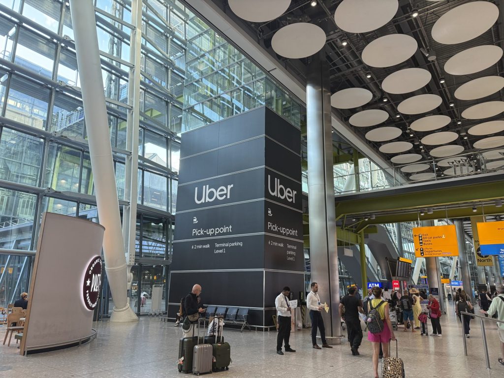 The Uber pick-up point sign inside Terminal 5, two minutes from arrivals