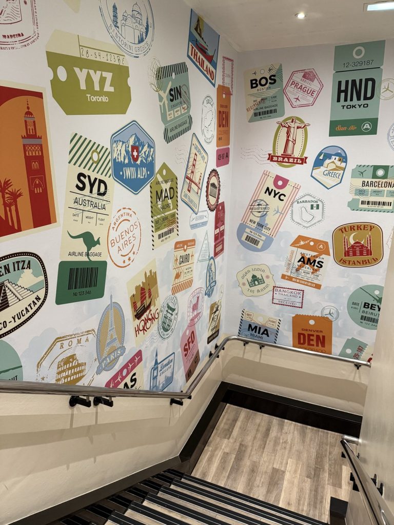 The stairwell decorated with airport luggage tags