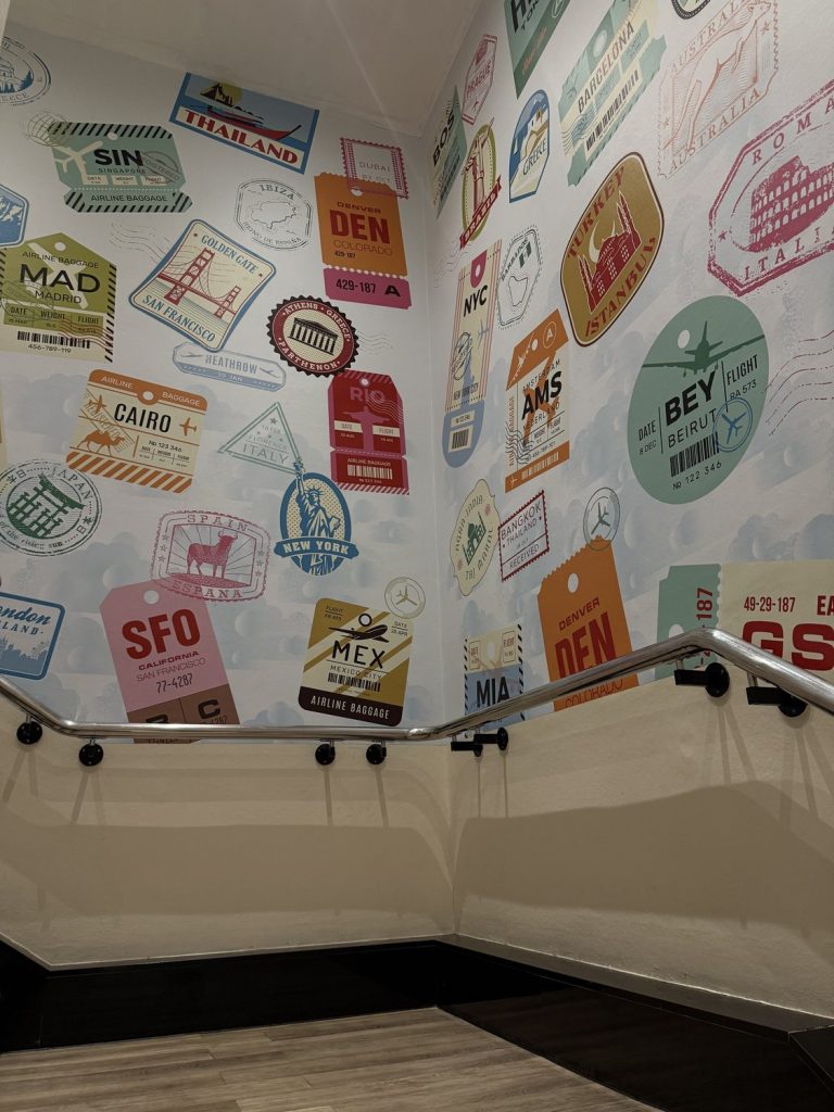 The wall of airport luggage tags in the hotel