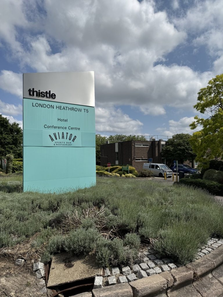 The Thistle sign at the entrance, with the hotel building behind it